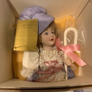 Porcelain Doll with Purple Hat and Pink Ribbon